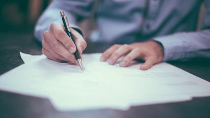 man writing a letter